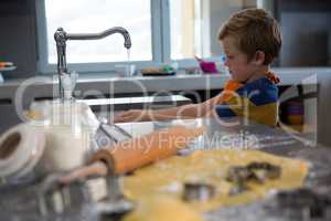 Boy washing hands in kitchen