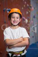 Boy standing with arms crossed in fitness studio