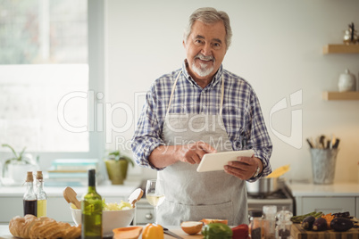 Senior man using digital tablet