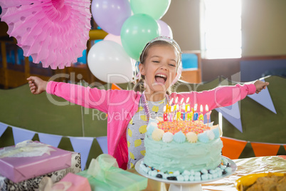 Birthday girl looking at cake