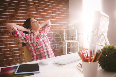 Female executive relaxing at her desk