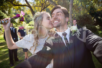 Affectionate woman kissing man during wedding