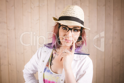 Thoughtful woman holding notepad and pen