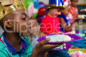 Close up of boy looking at cake in plate