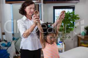 Physiotherapist giving hand massage to a girl