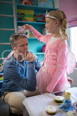 Father and daughter in fairytale dressing playing together