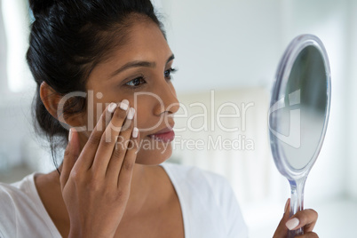 Close-up of woman holding hand mirror
