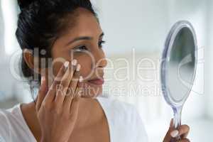 Close-up of woman holding hand mirror