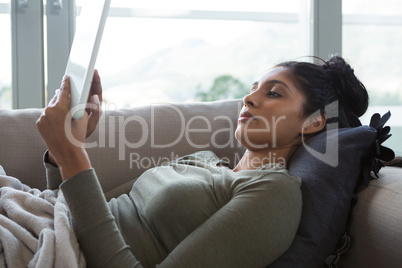 Woman using tablet on sofa