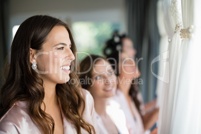 Smiling women looking at wedding dress