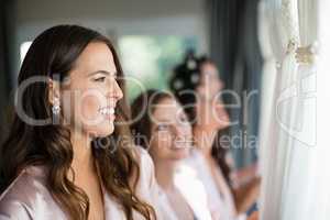 Smiling women looking at wedding dress