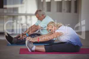 Senior couple performing stretching exercise