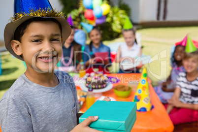 Portrait of boy showing gift box