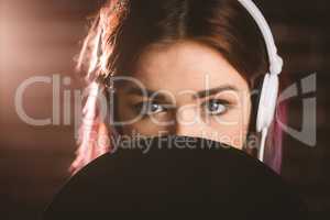 Portrait of woman listening music on headphones