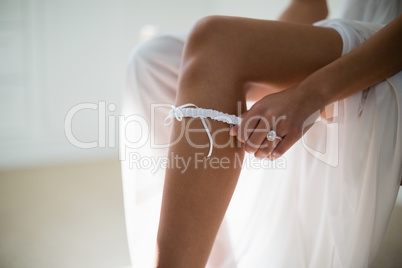 Bride wearing stockings in living room