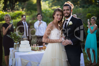 Newly married couple holding glasses of champagne