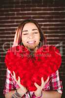 Smiling woman holding heart shape