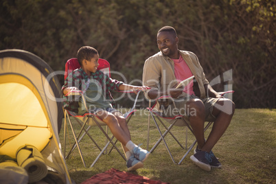 Father and son interacting with each other in park