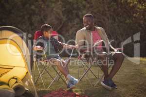 Father and son interacting with each other in park