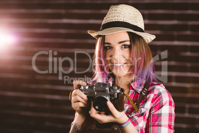 Portrait of smiling woman holding vintage camera