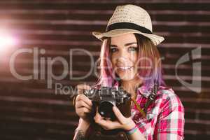 Portrait of smiling woman holding vintage camera
