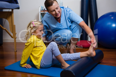 Physiotherapist giving physical therapy to the girl