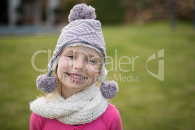 Smiling girl standing in the garden