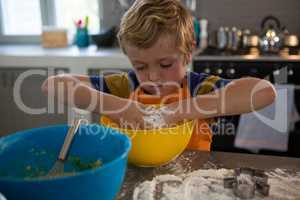Boy mixing dough in yellow bowl