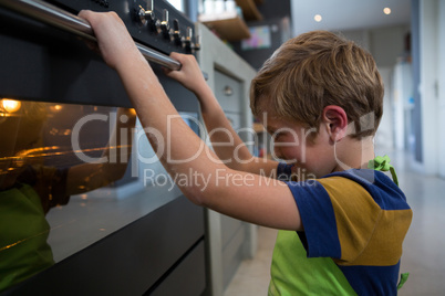Boy looking at oven