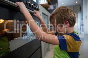 Boy looking at oven