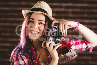 Portrait of smiling woman posing with vintage camera
