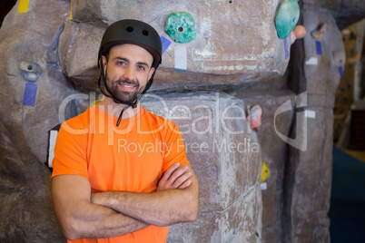 Trainer standing with arms crossed in fitness studio