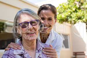 Portrait of smiling senior woman with doctor