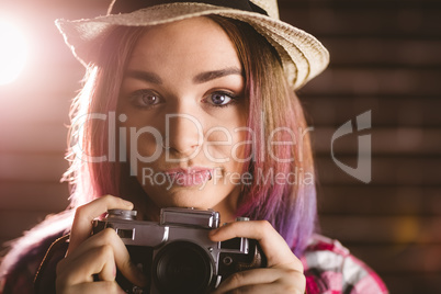 Portrait of woman holding vintage camera