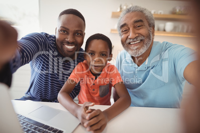 Happy multi-generation family looking at camera