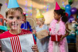 Portrait of happy boy showing gift