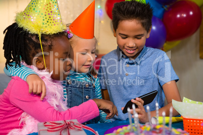 Kids looking at smartphone