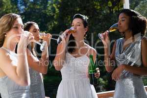 Bride and bridesmaids having champagne