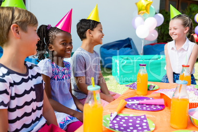 Happy children talking at table