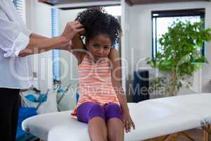 Physiotherapist giving hand massage to a girl