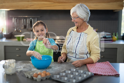 Granddaughter holding eggs and grandmother smiling