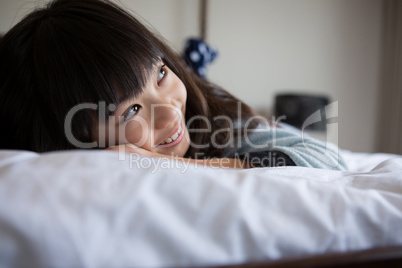 Smiling girl resting on bed
