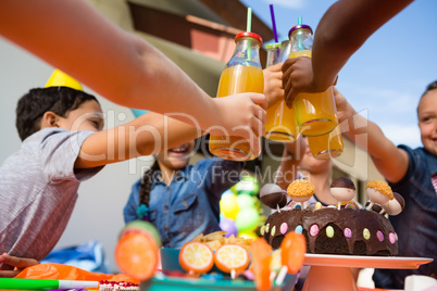 Close up of children toasting juice