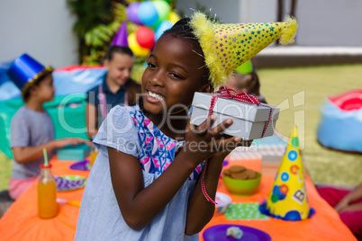 Girl listening to gift box