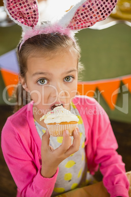 Birthday girl eating a cupcake