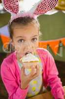 Birthday girl eating a cupcake