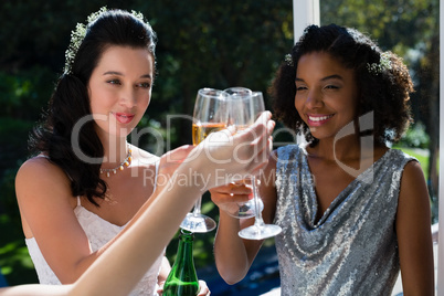 Bride and bridesmaids toasting champagne