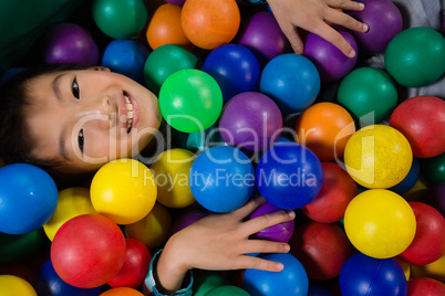 Directly above portrait of boy in ball pool