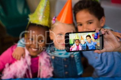 Children talking selfie at party
