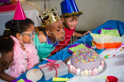 Boy blowing candles on cake
